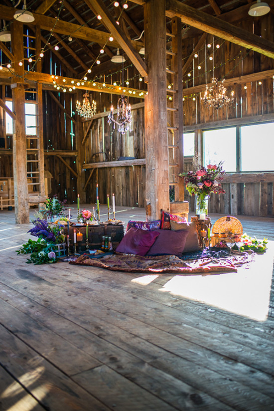 Rustic barn interior with chandeliers and floral decor
