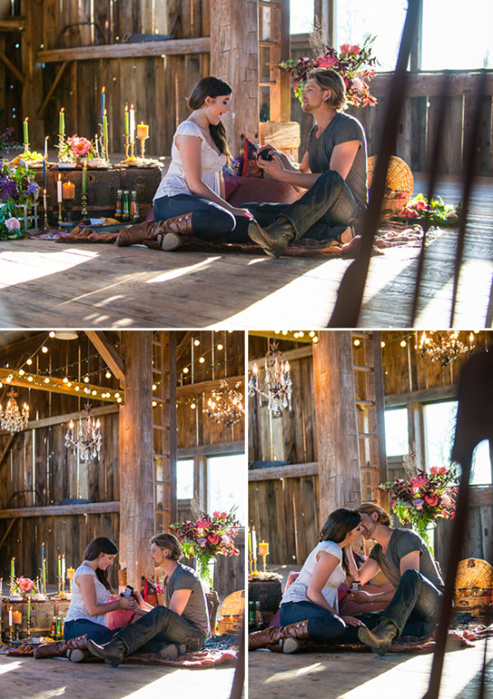A man proposes to a woman in a rustic barn setting