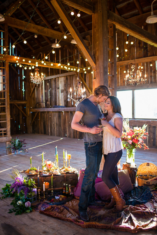 Couple celebrating in rustic barn with lights and decor