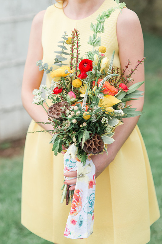 Vibrant yellow bridesmaid bouquet with red and orange flowers