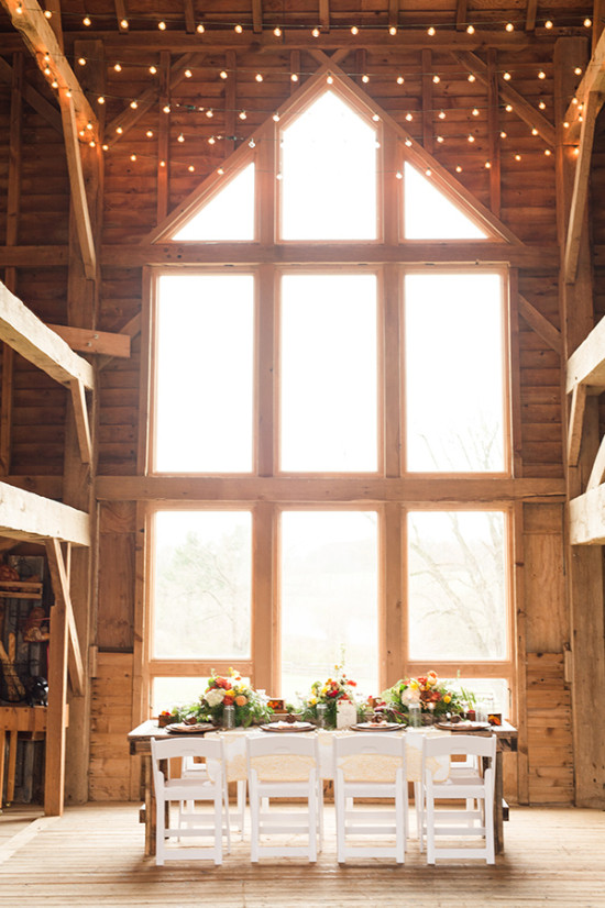 Rustic barn wedding reception table with large window