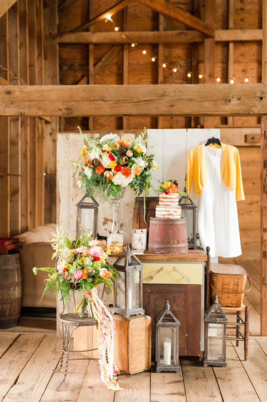 Rustic barn wedding decor with flowers and lanterns