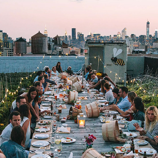 Rooftop dinner party with skyline views at sunset