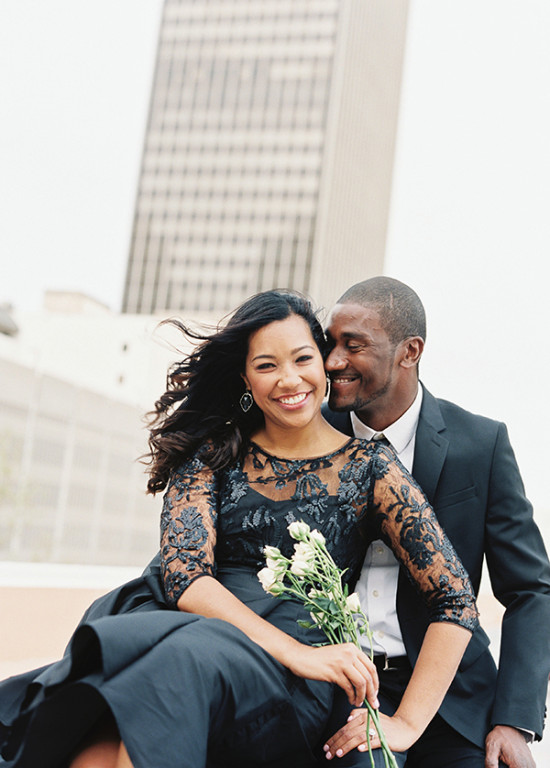 Happy couple in formal wear against a cityscape backdrop