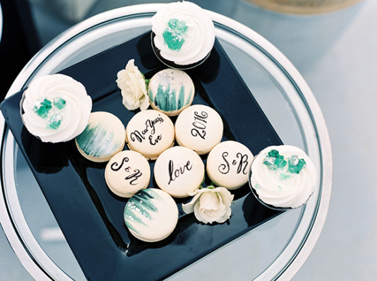 New Years Eve macarons and cupcakes on a black tray