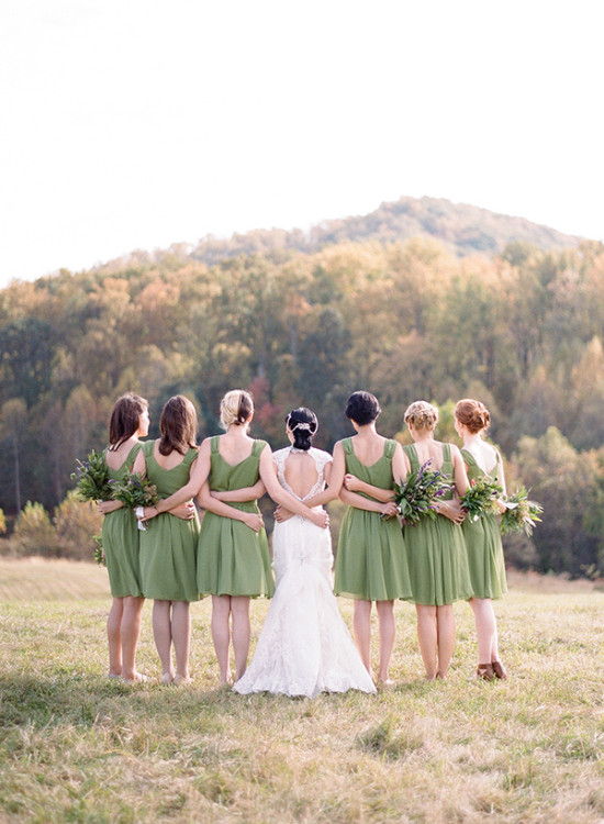 Bride and bridesmaids in green dresses at outdoor wedding