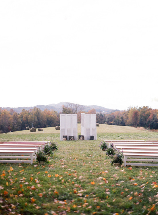 Rustic field wedding ceremony with white panels altar