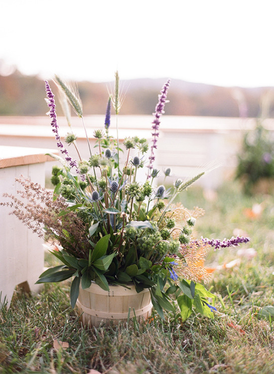 Rustic wildflower bouquet in wooden bucket outdoor setting