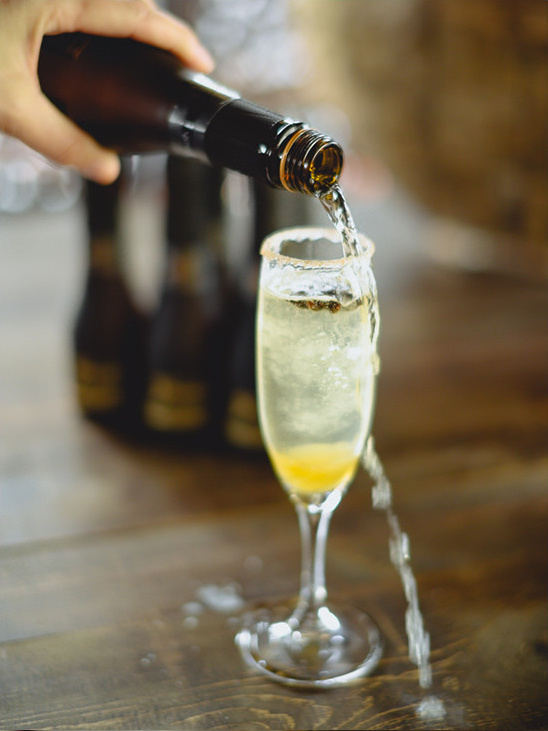 Pouring sparkling wine into a sugar rimmed champagne flute