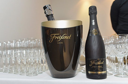 Freixenet Cava in an ice bucket with champagne flutes
