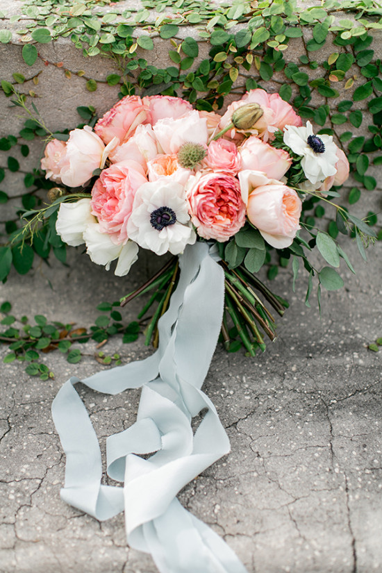 Pink and white wedding bouquet with trailing blue ribbon