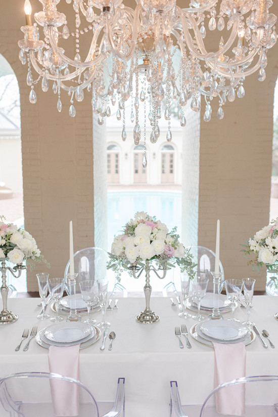 Elegant crystal chandelier over a luxurious wedding table