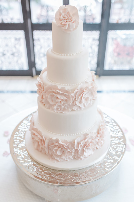 blush and white wedding cake with sugar rose accents