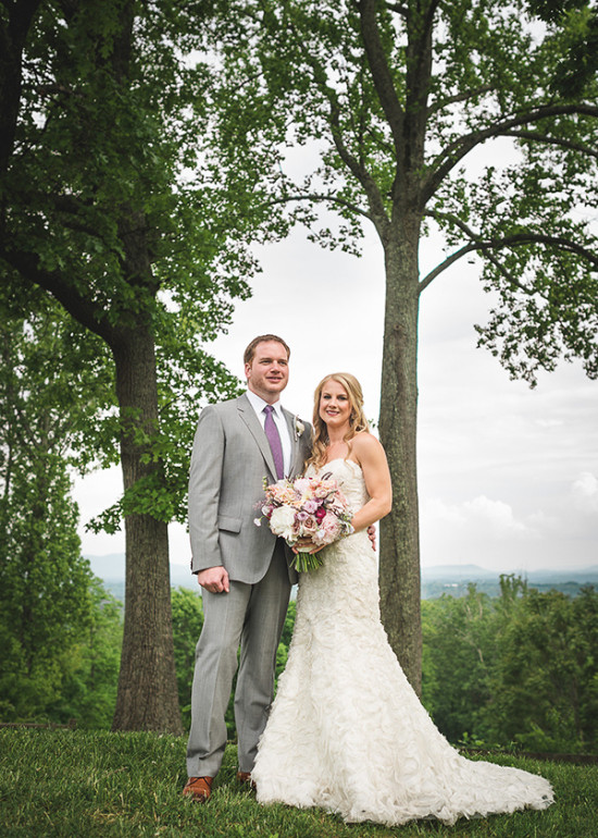Bride and groom pose on their wedding day outdoors
