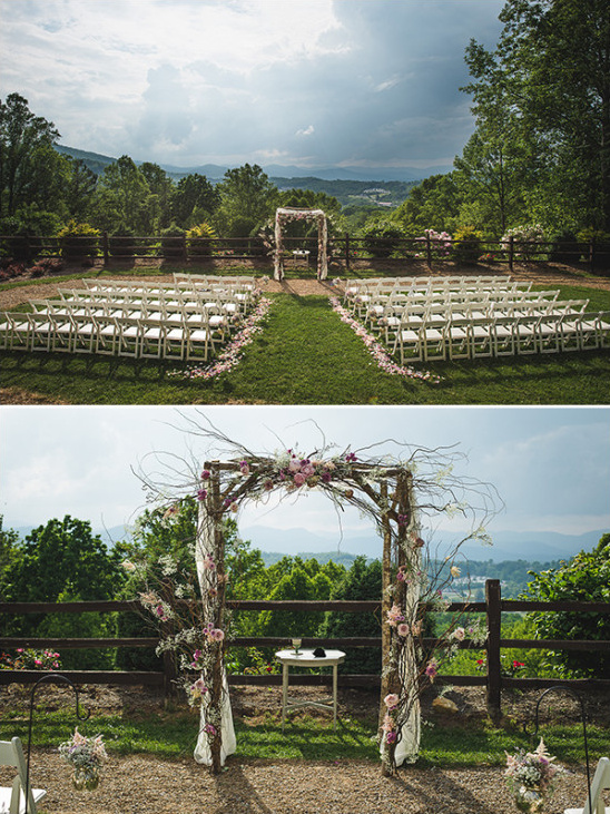 Outdoor wedding venue with a floral arch and mountain view