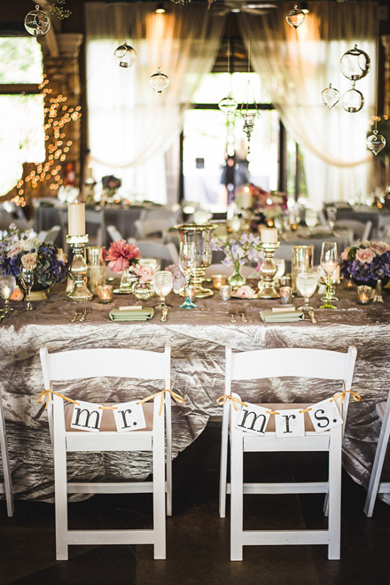 Mr and Mrs chairs at elegant wedding reception table