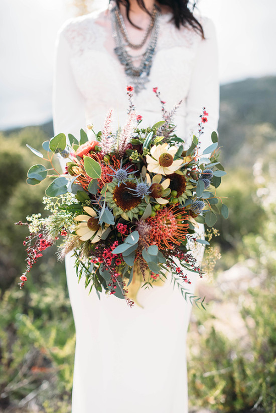 Bride with vibrant sunflower wedding bouquet outdoors