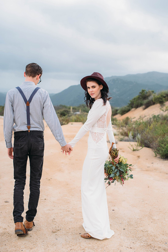Romantic wedding couple holding hands outdoors in nature