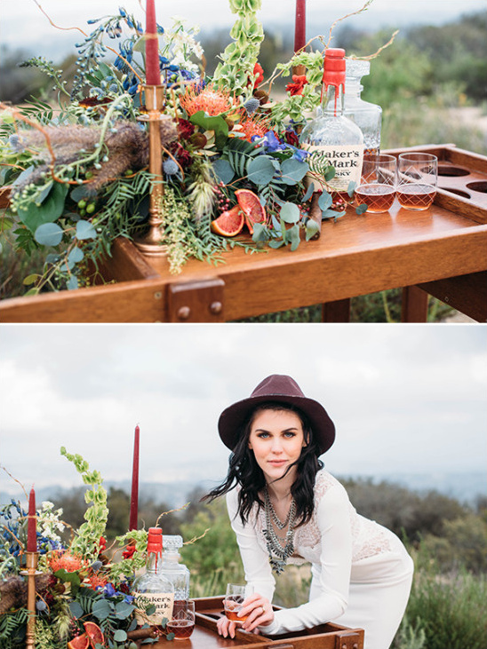 Woman with Maker's Mark on styled bar cart with flowers