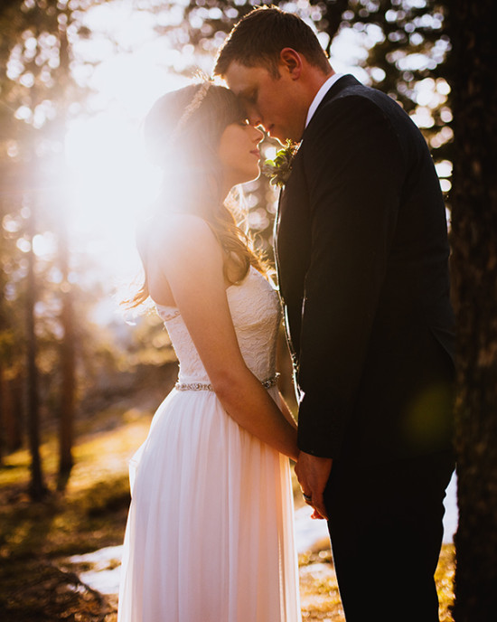 Bride and groom tender moment at sunlit wedding
