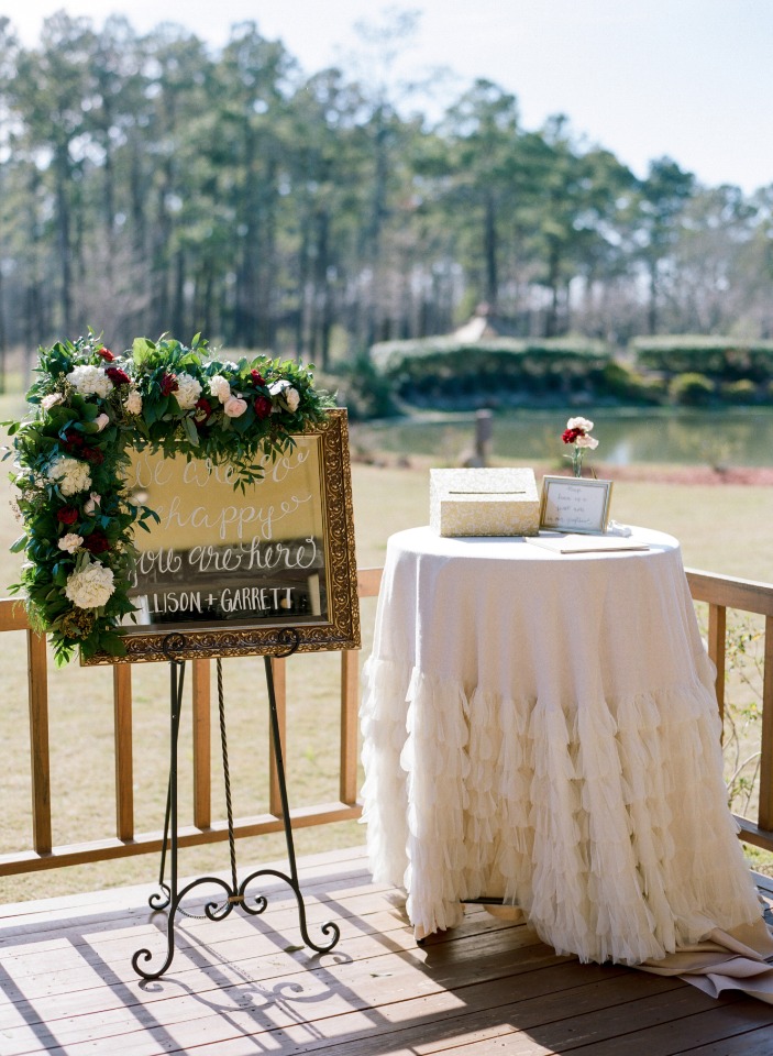 Welcome sign and gift table at outdoor wedding venue