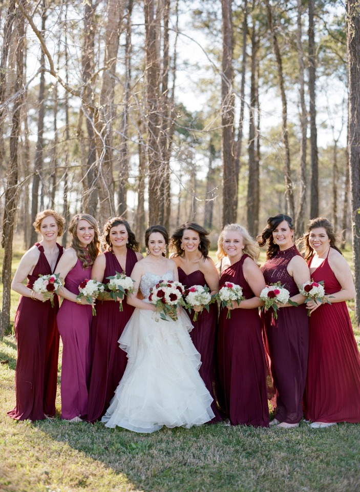 Bride and bridesmaids in burgundy dresses outdoors