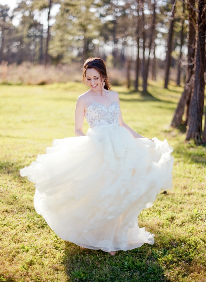Bride twirling in her wedding gown in nature setting