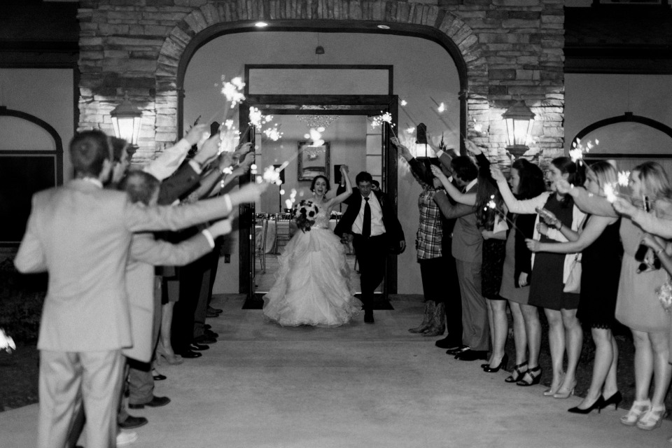 Bride and groom exit with sparklers in black and white
