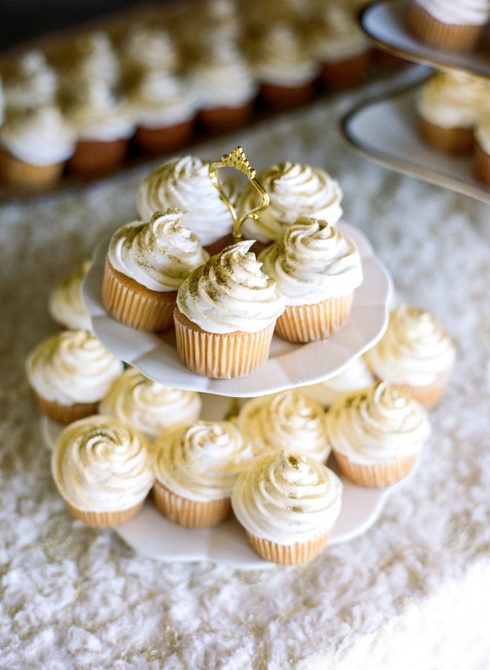 Elegant cupcakes with white frosting on a tiered tray