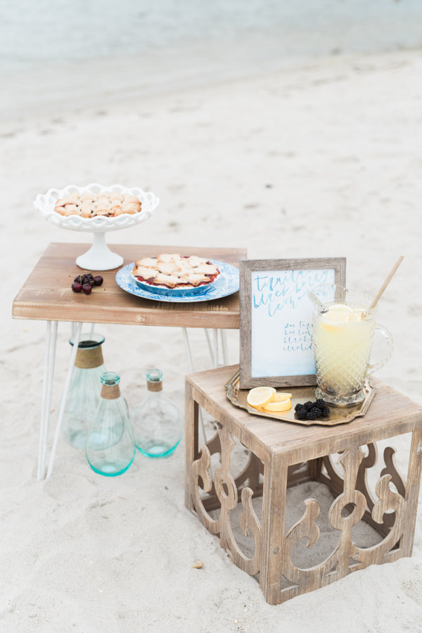 Beach picnic with pie and lemonade on rustic tables