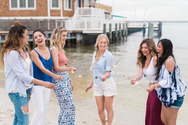 Friends celebrating with sparklers on the beach