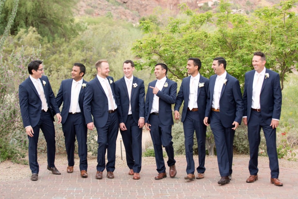 groomsmen in matching navy suites with blush ties
