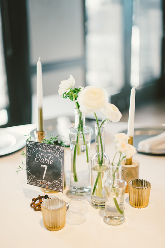 minimalist gold and white centerpiece with chalkboard style table number