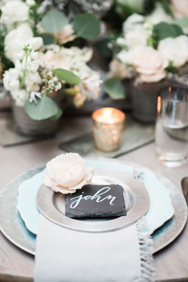 silver and blue place setting with slate place card