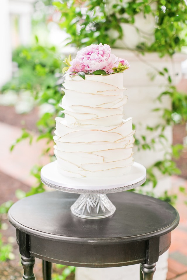 gold edged ruffle cake with beautiful flower topper