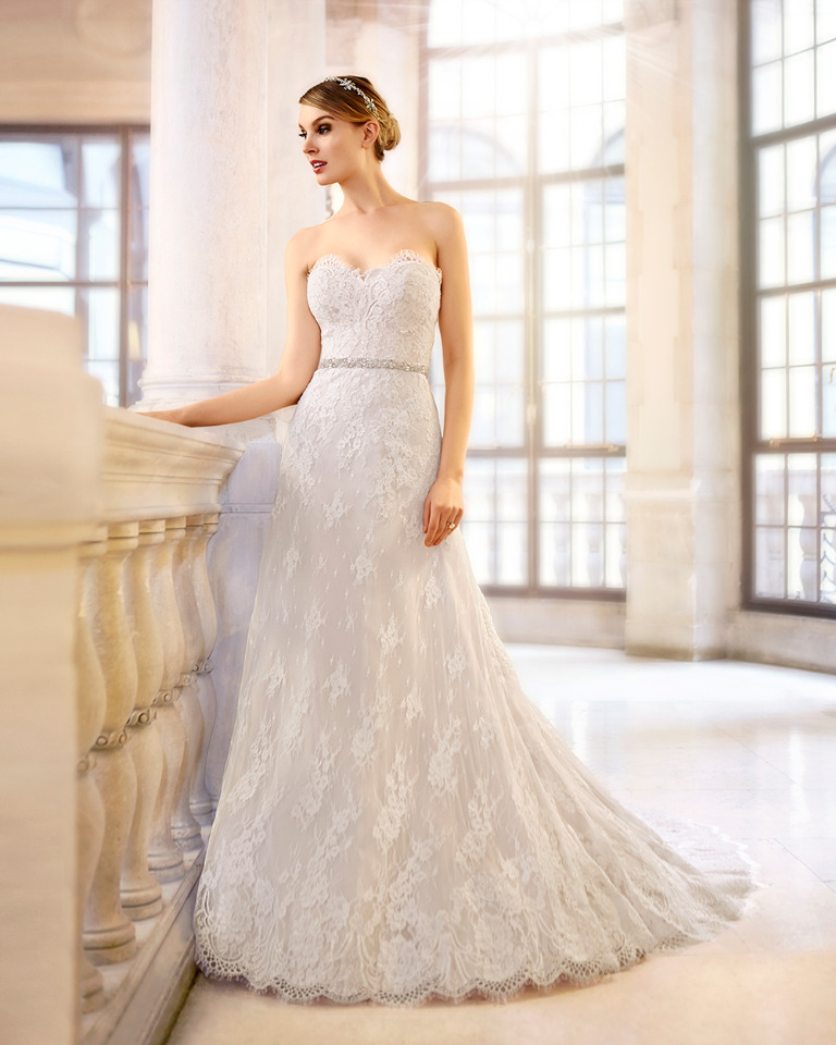 Elegant bride in strapless lace wedding gown