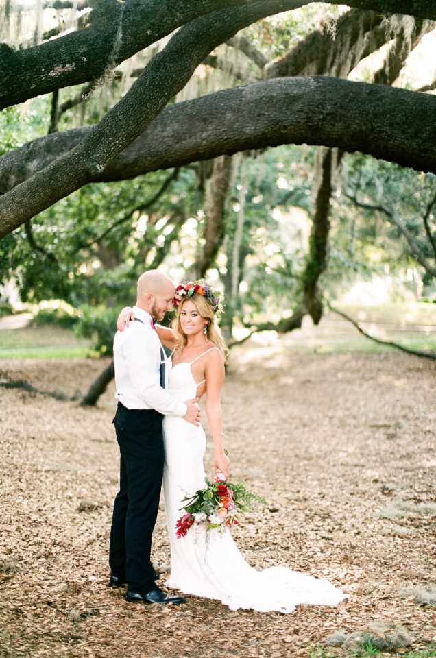 boho bride with groom in classic suspenders and bow tie