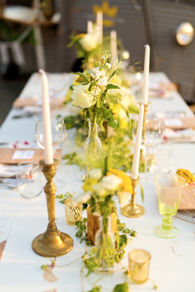 White yellow and green centerpieces with candlesticks