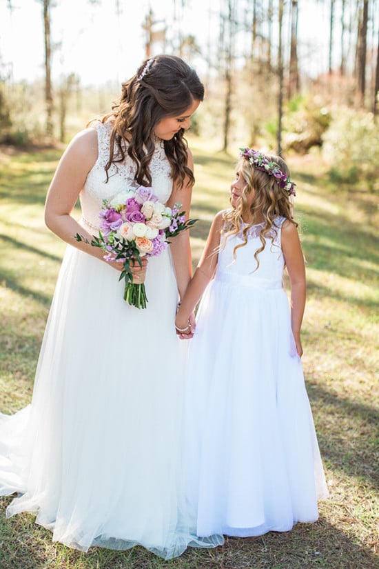 bride and her flower girl dressed in all white