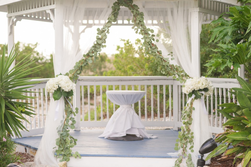 wedding gazebo with greenery garland and florals