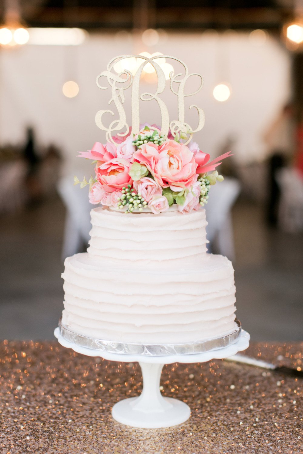 classic simple wedding cake with gold topper