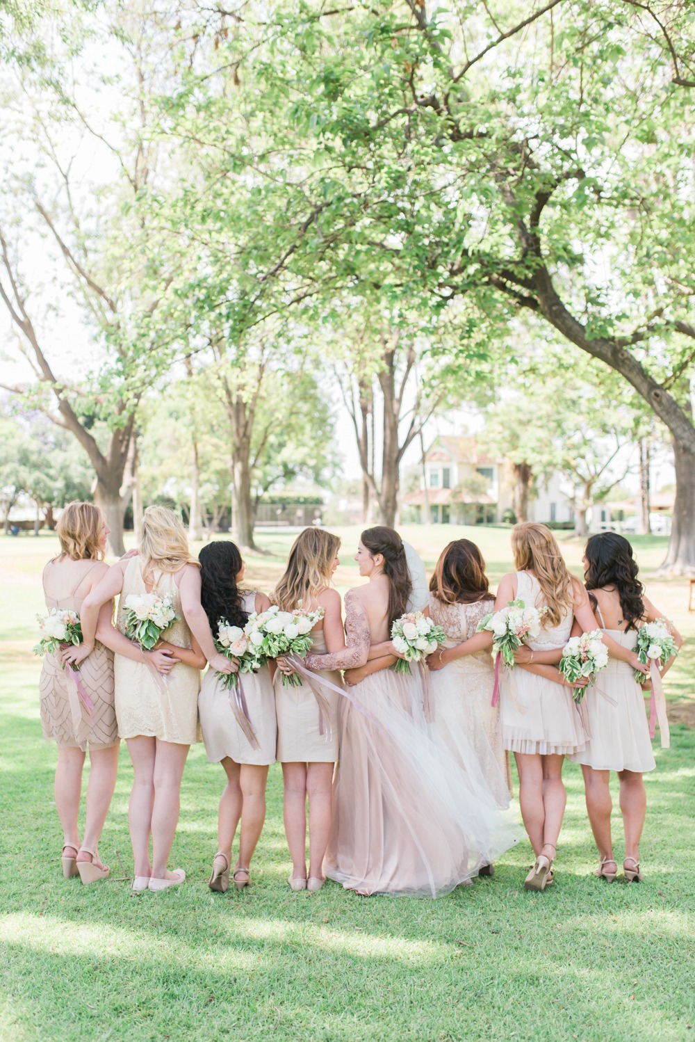 Bridesmaids in short mismatched dresses