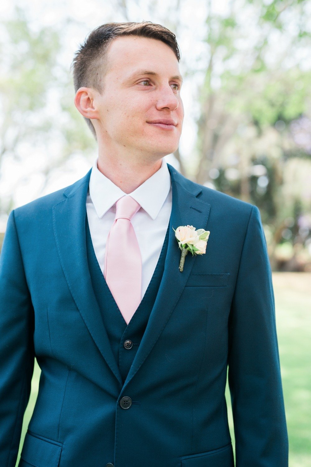Groom look in Navy with blush tie