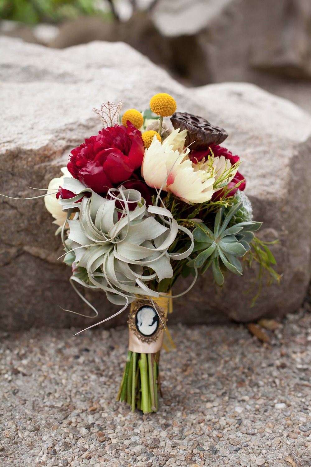 air plant peony and succulent bouquet with broach bouquet wrap
