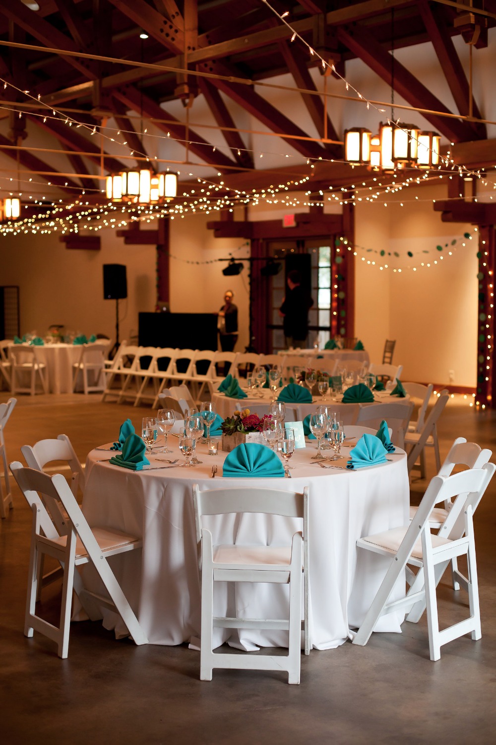 twinkle lights and teal and white reception decor