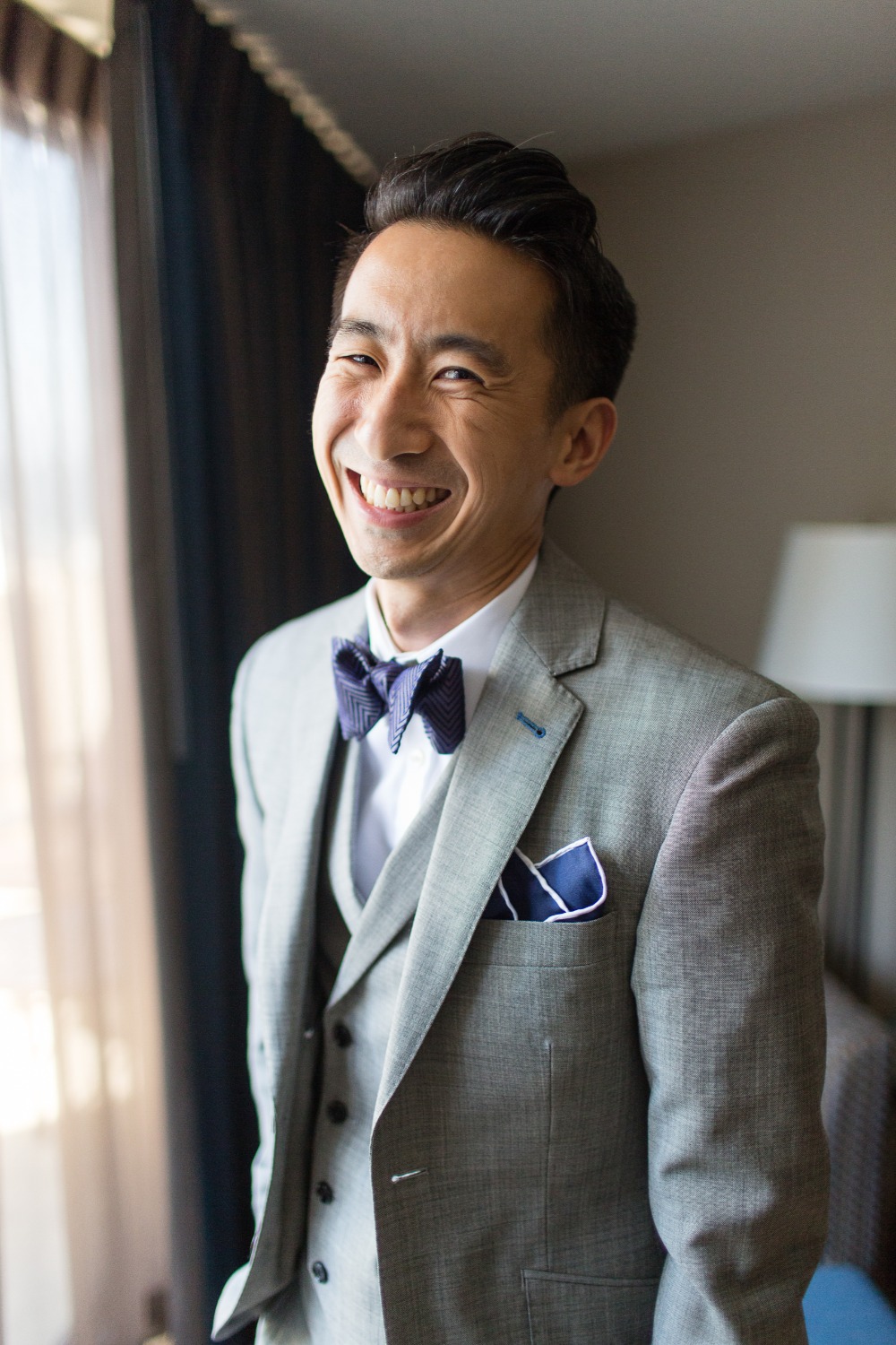 Groom in gray suit with bowtie