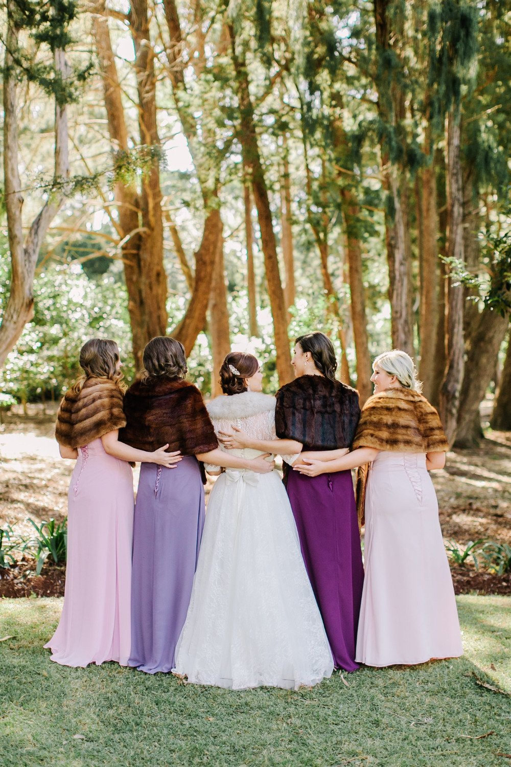 purple bridesmaids with fur wraps
