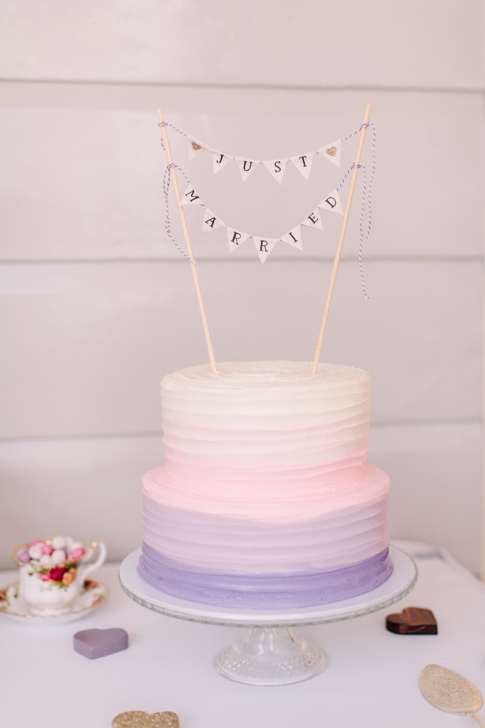 purple ombre wedding cake with bunting