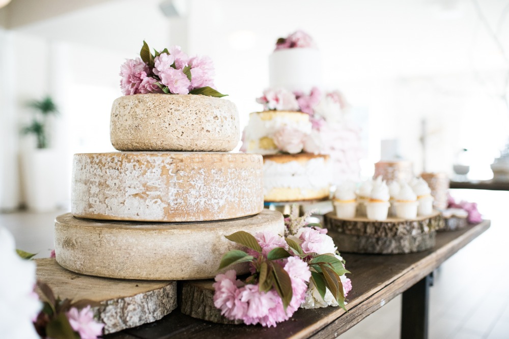 stacked wheels of cheese make a fun spin on wedding cake