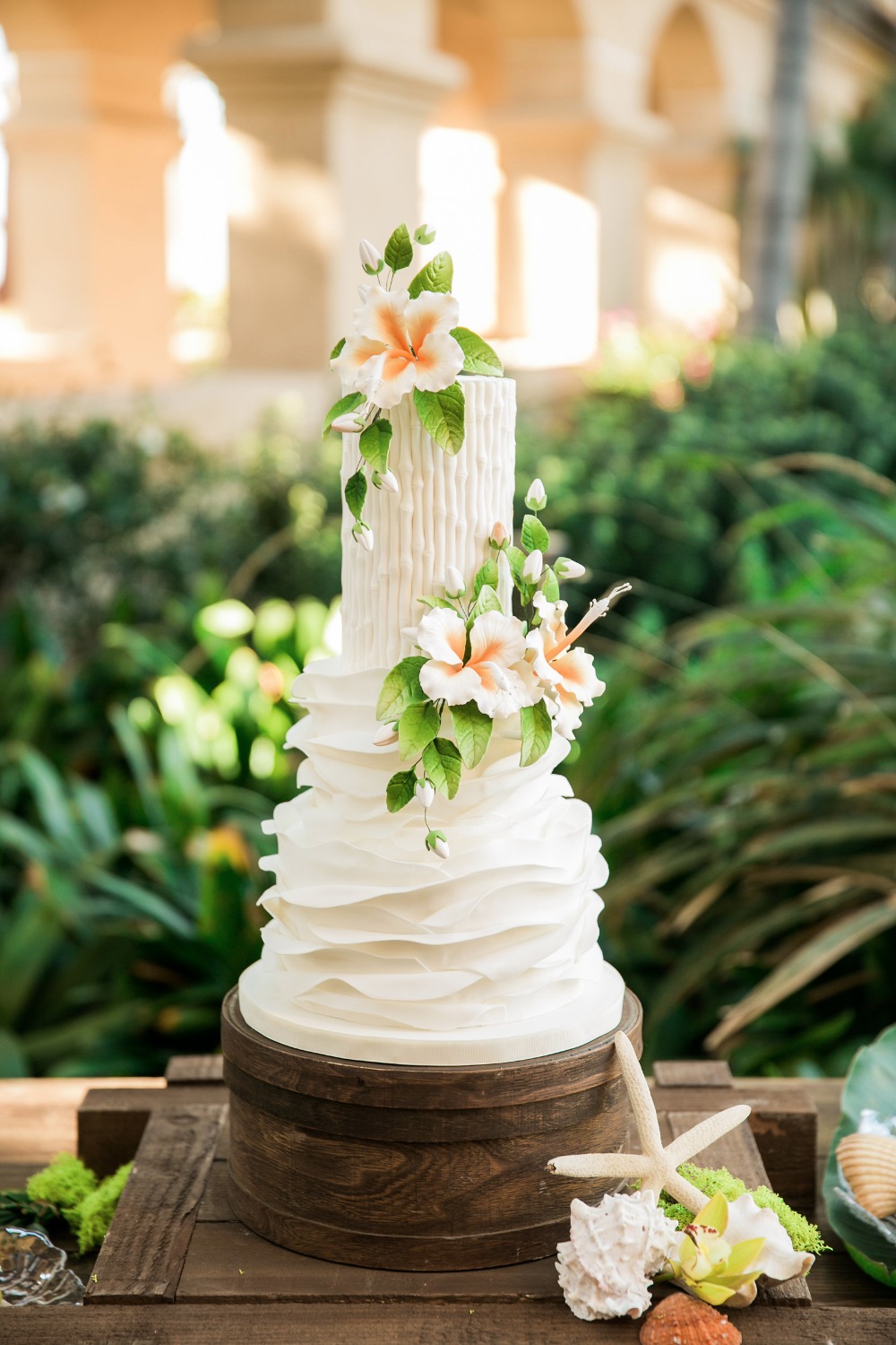 Tropical white wedding cake with flowers